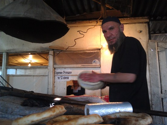 We bought bread from this guy, the traditional Central Asian bread is kneaded flat, and then slapped against the wall of a clay oven to bake it. 